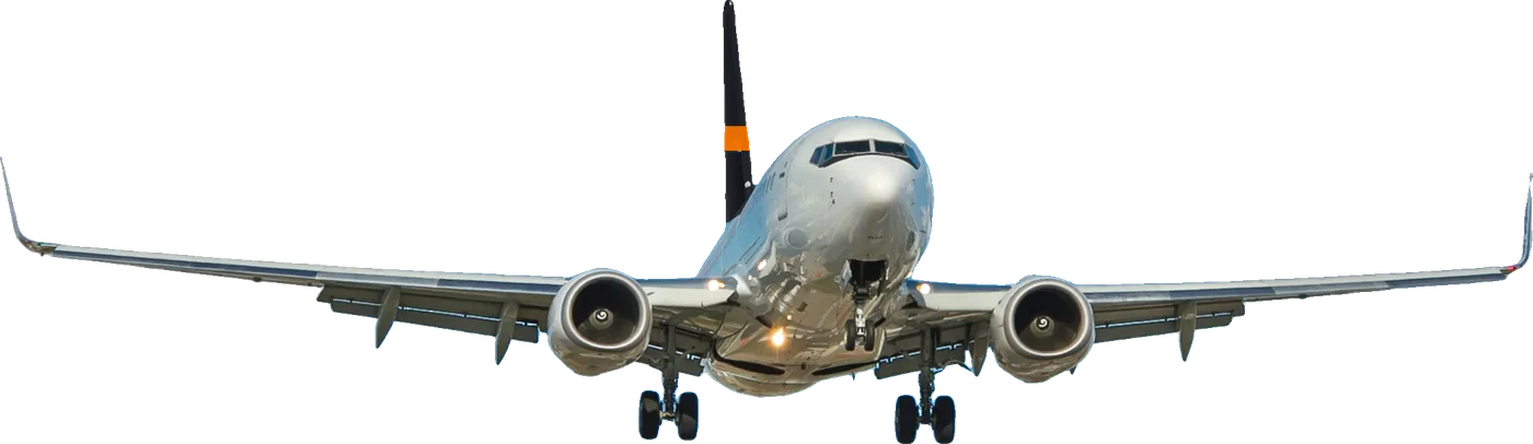 A twin-engine jet on approach under a blue sky