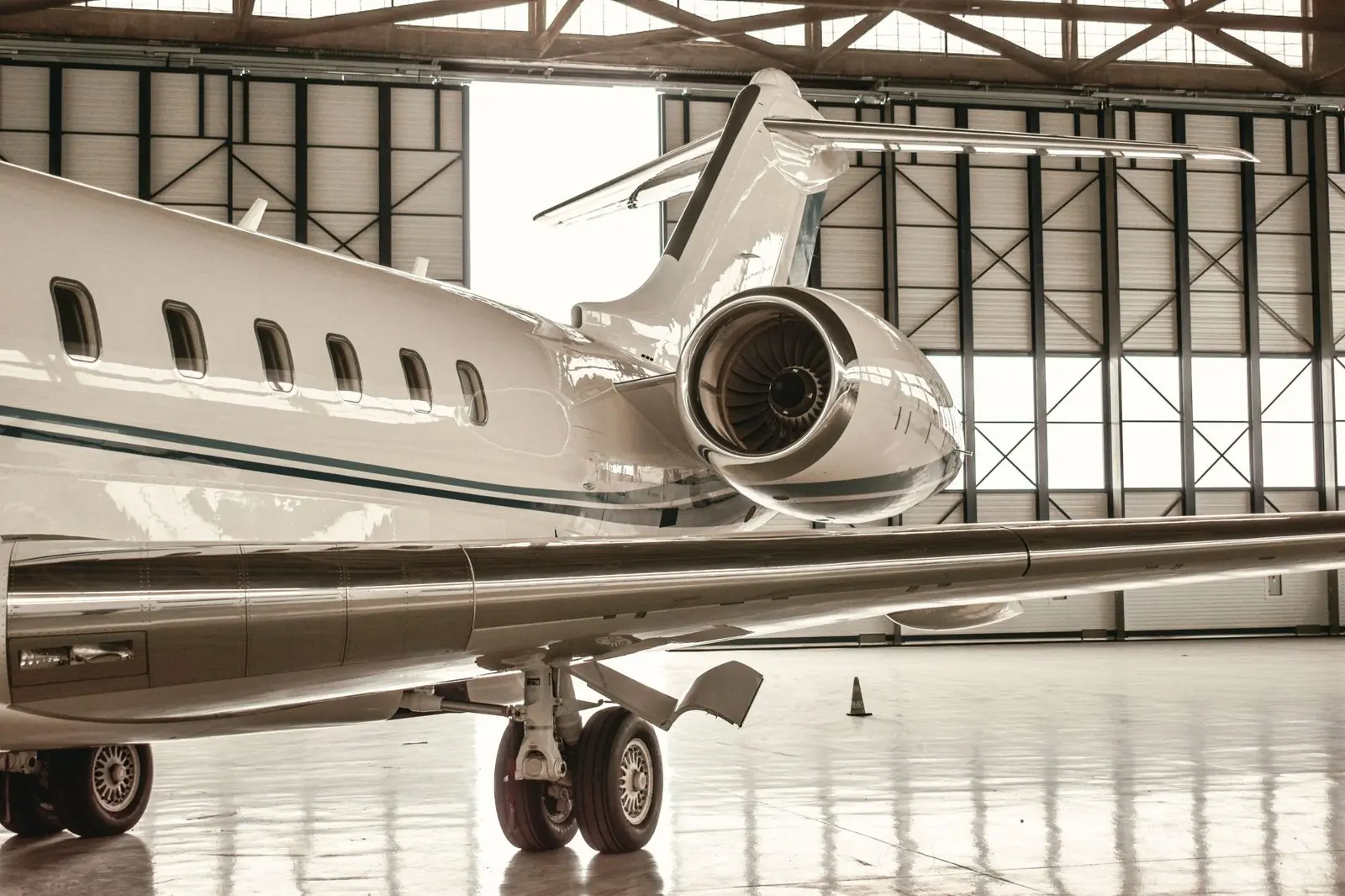 Business jet parked in a maintenance hangar